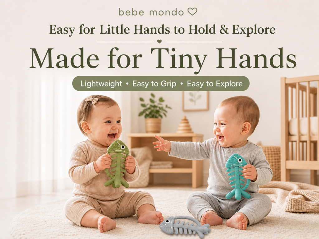 two babies are playing and chewing fish teethers baby teething toys together and smiling